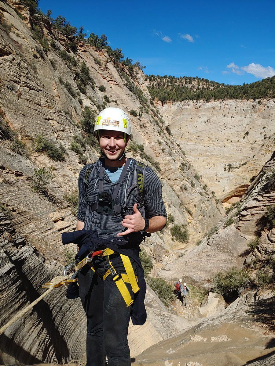 a person wearing a helmet while rappelling