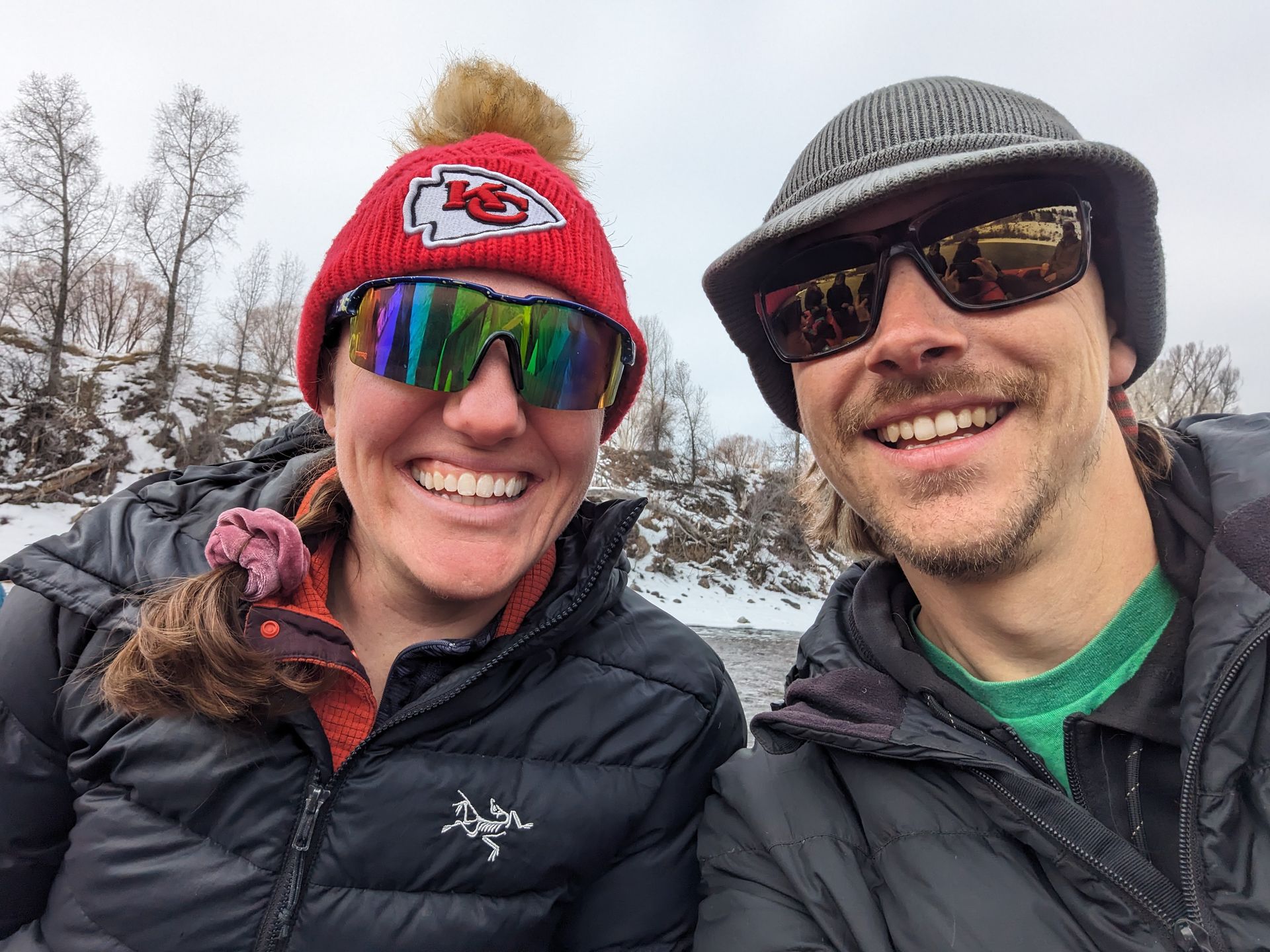 Jillian and Nathan are bundled up in the cold. Jillian is wearing a Kansas City Chiefs hat