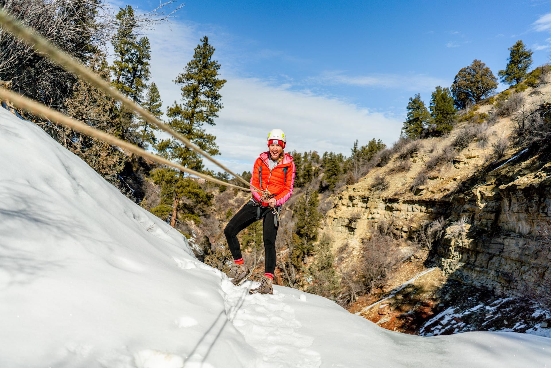 A Man Is Climbing up A Rock Wall