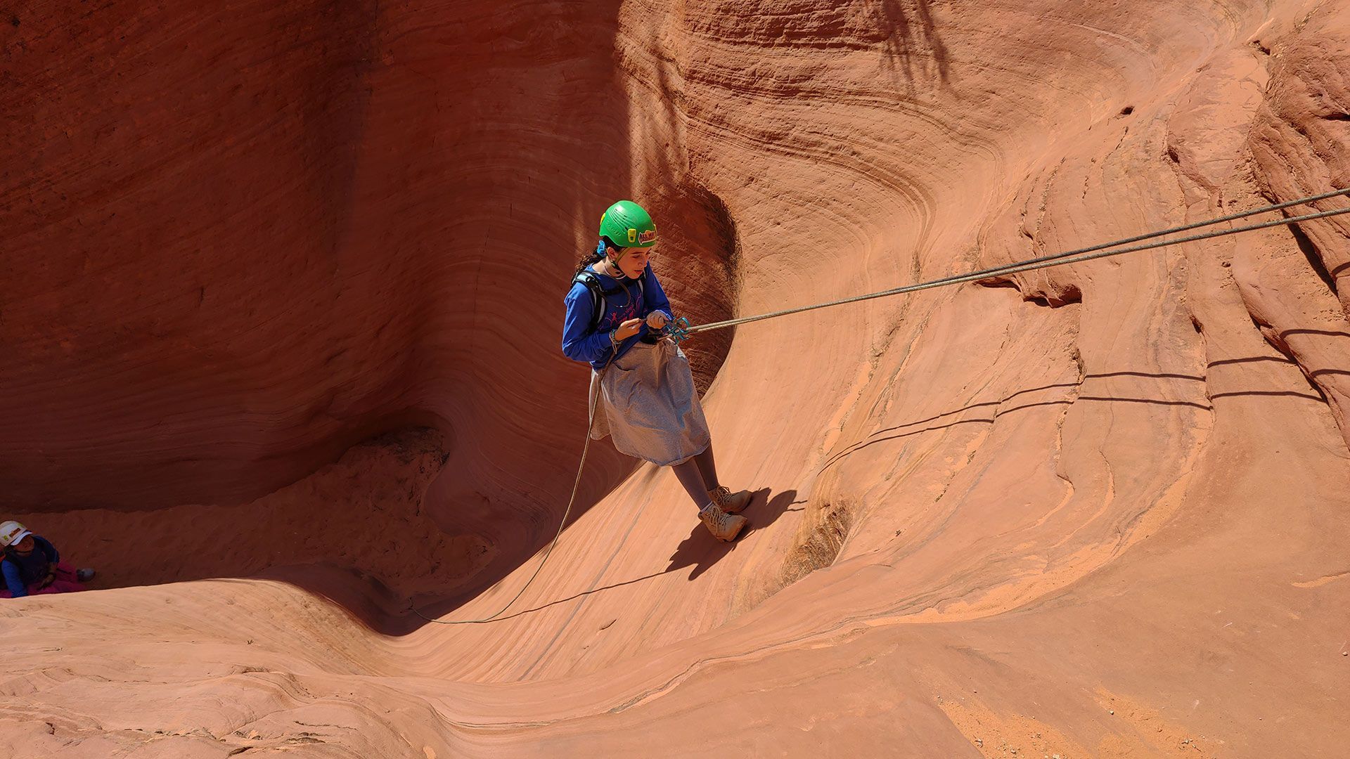 A Man Is Climbing up A Rock Wall