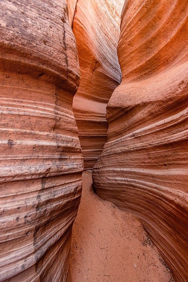 A canyon filled with rocks and sand in the desert.