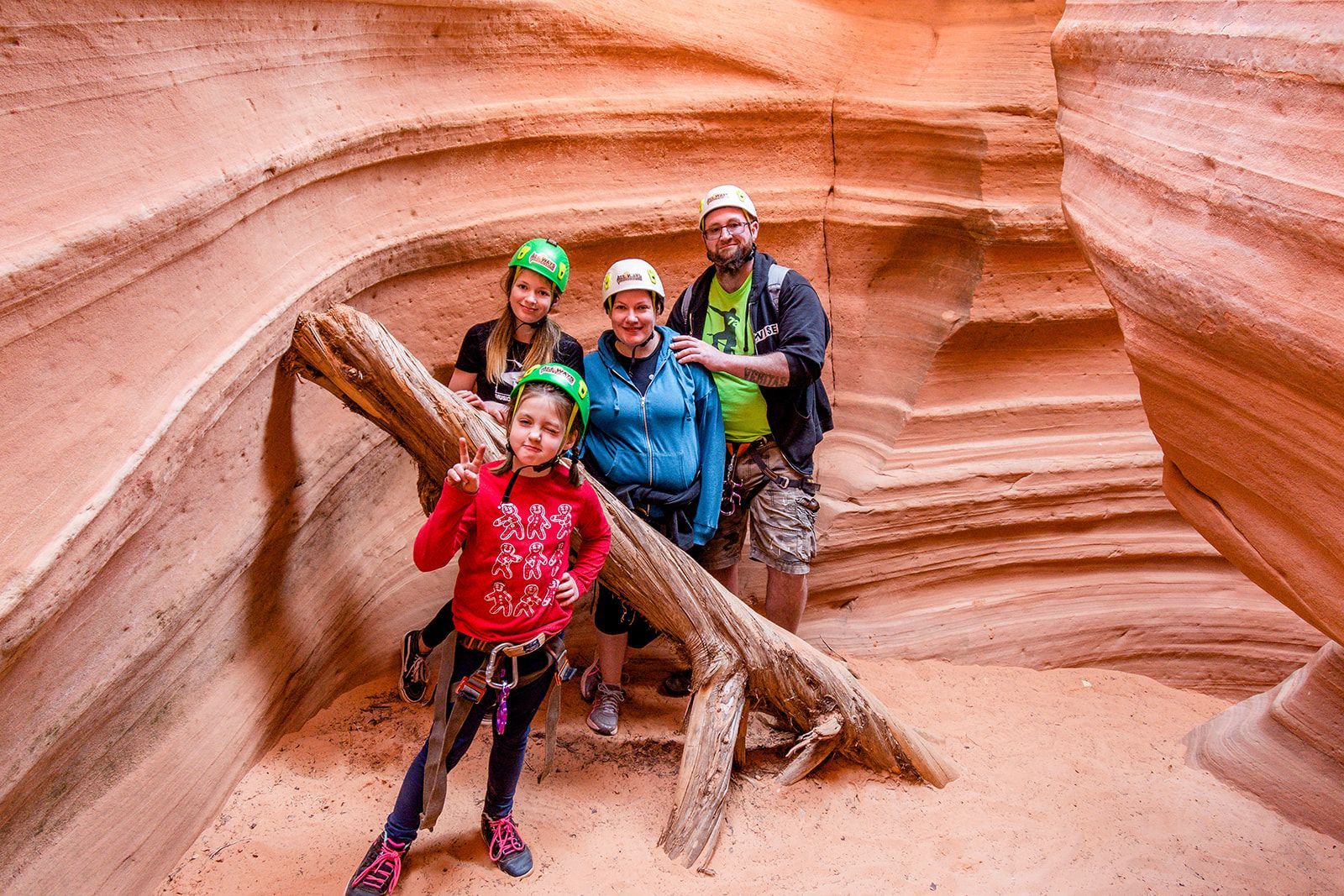 A family posing for a picture in a canyon wearing helmets