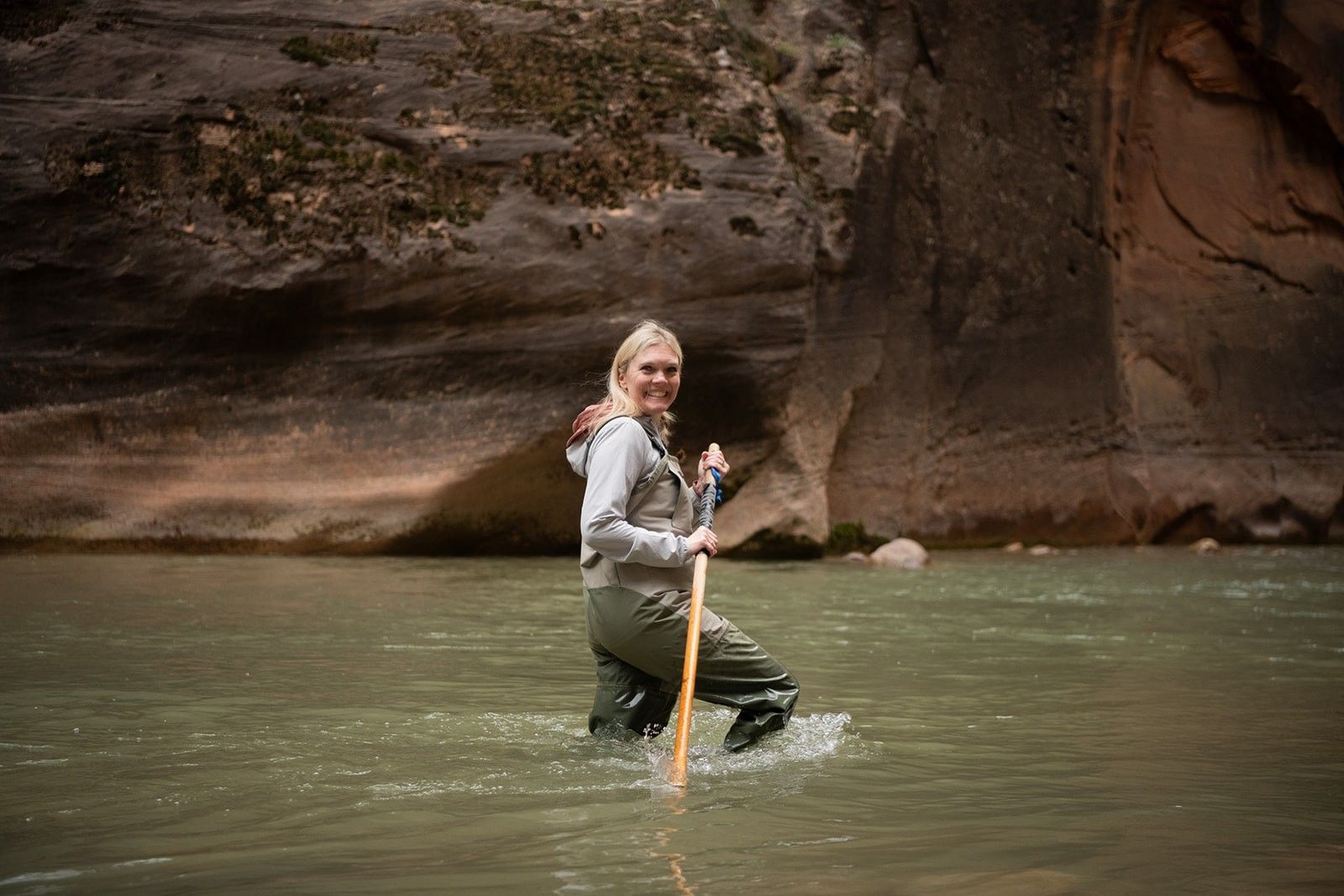 A person wades through the stream in Zion National Park