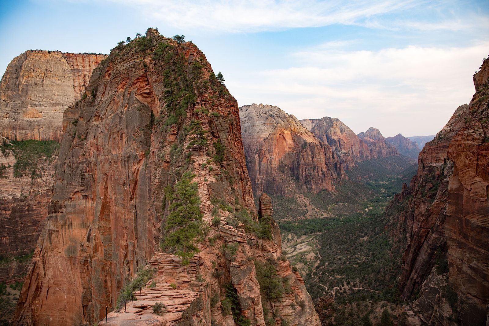 Red towering cliffs with shrubs lining their base