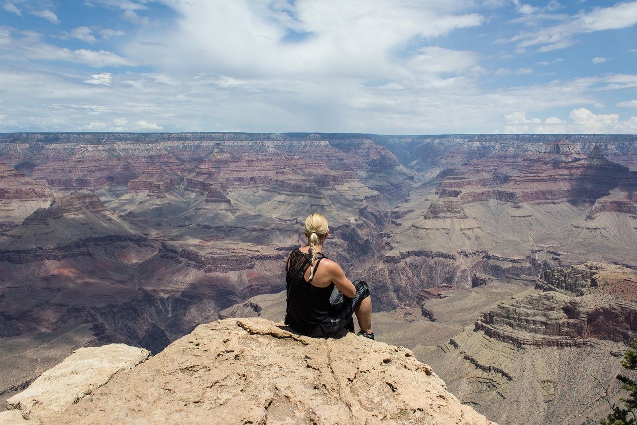 A person looks out over the Grand Canyon