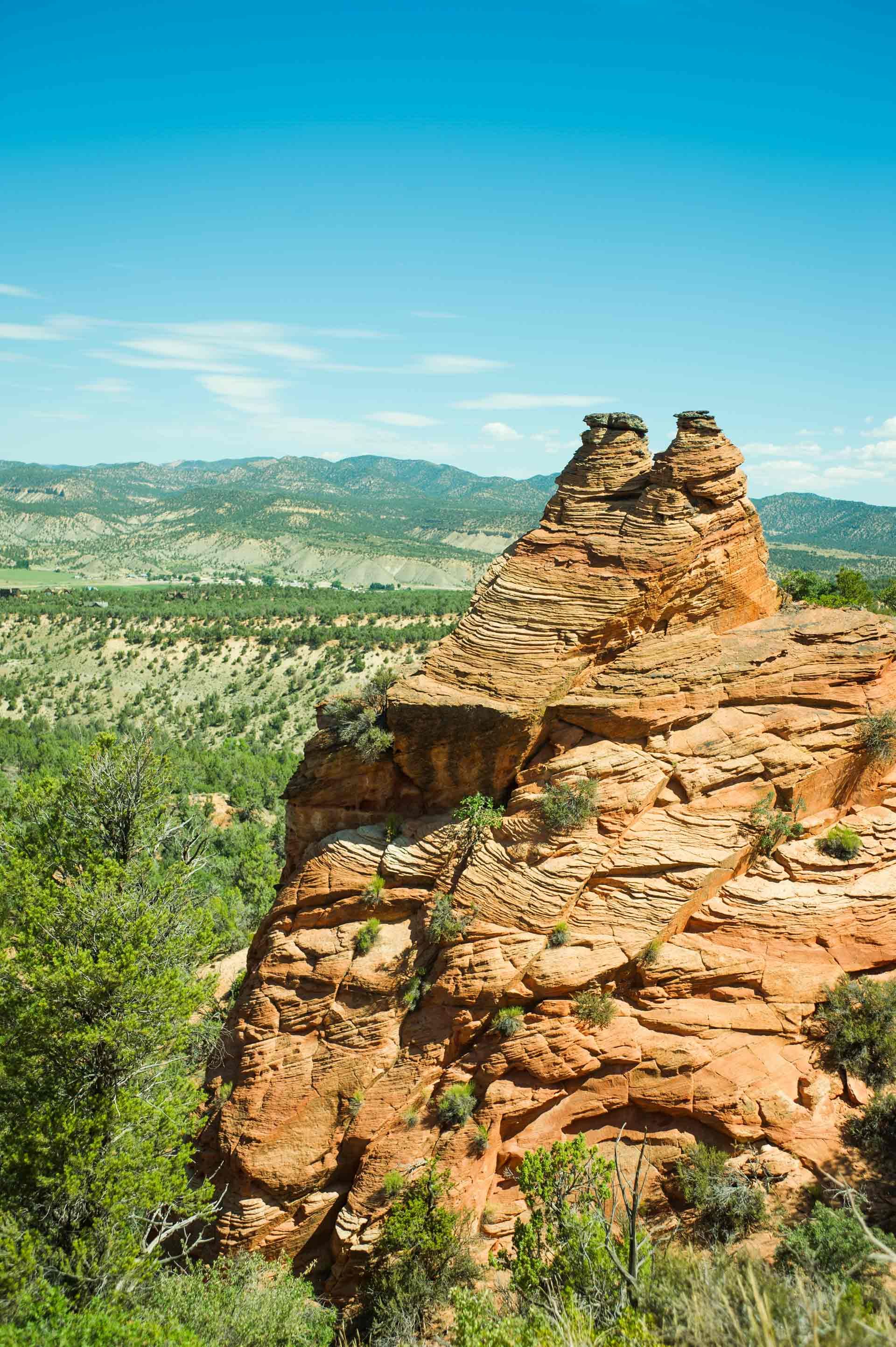 A large rock formation in the middle of a valley