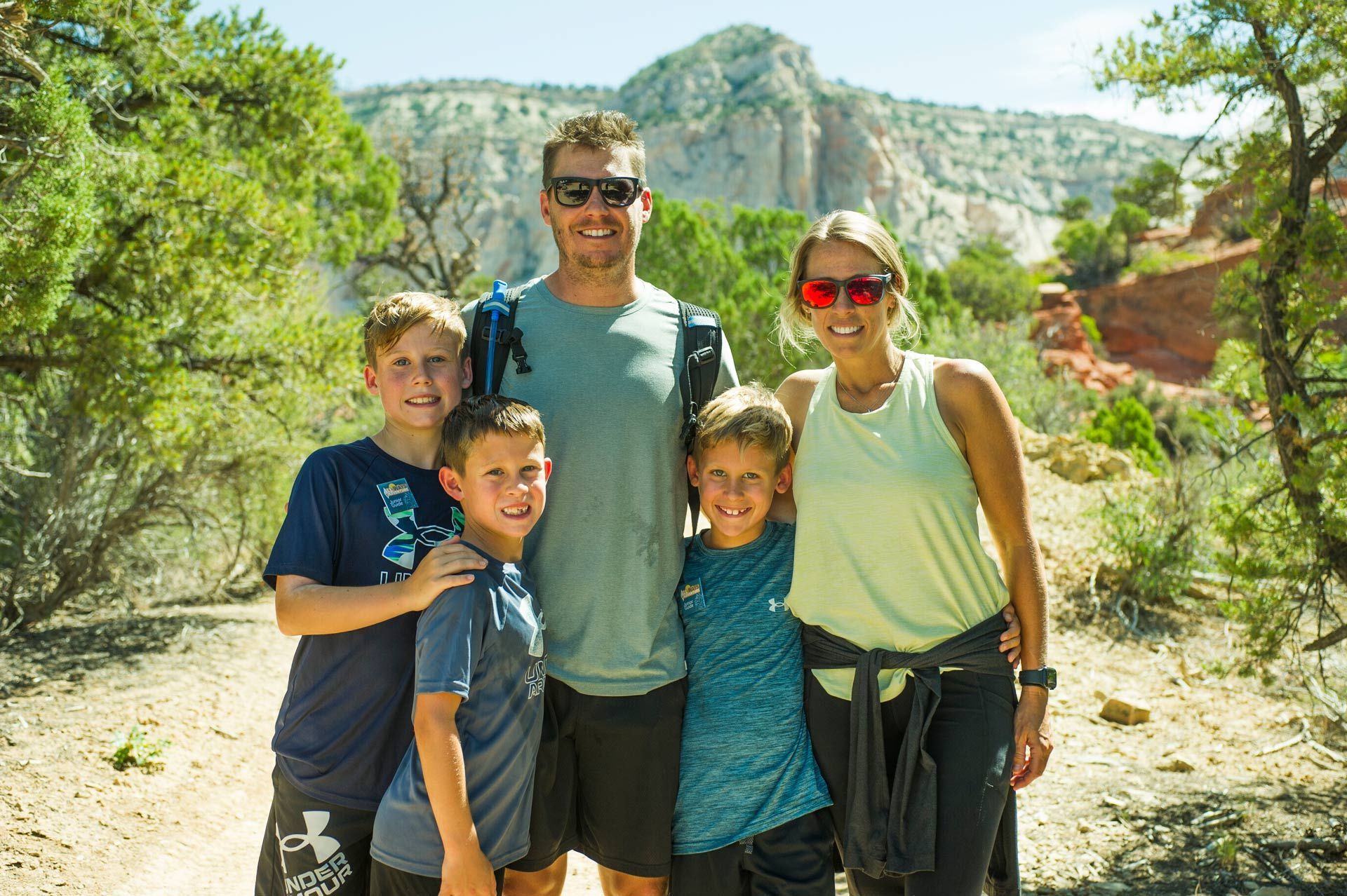 A family posing for a picture with mountains in the background