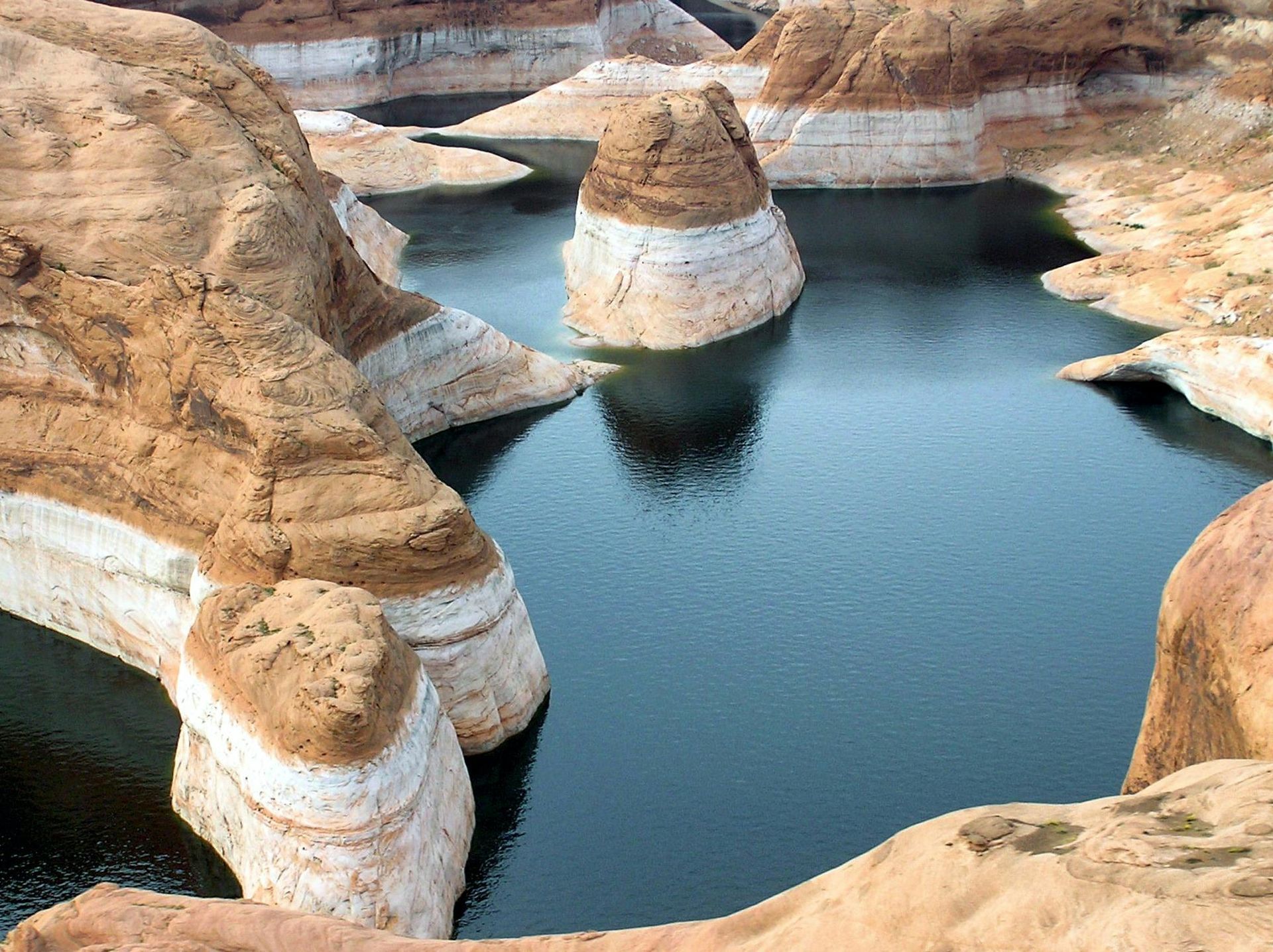 A large body of water surrounded by rocks and cliffs