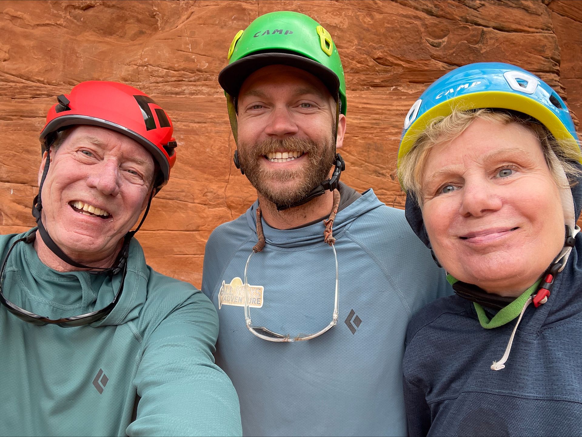 Brett is in the middle of two guests who are all posing for a selfie together