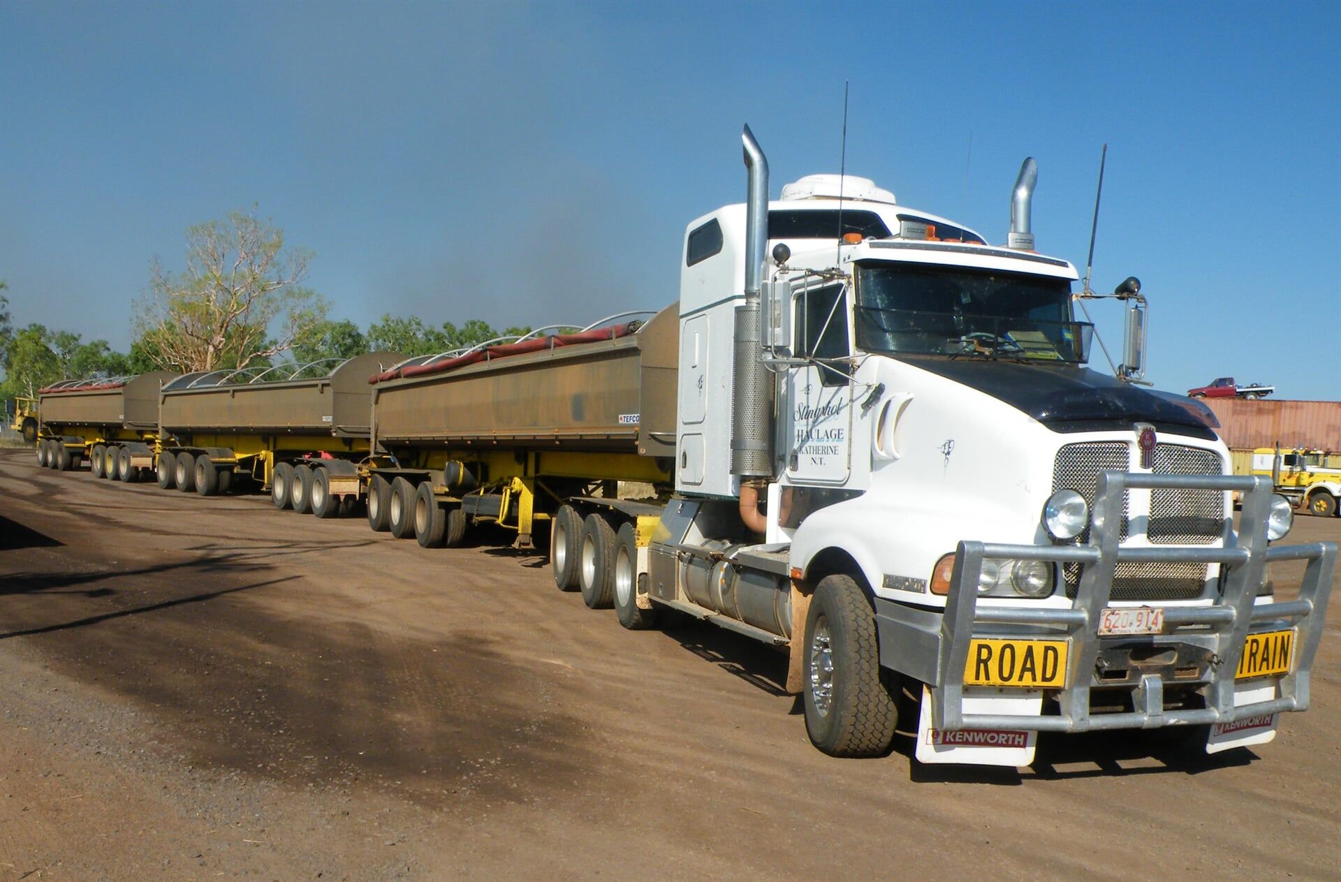 A white semi truck with a road sign on the front- Slingshot Haulage in Katherine, NT