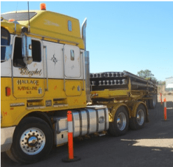 A yellow haulage truck is parked in a parking lot-Slingshot Haulage in Katherine, NT
