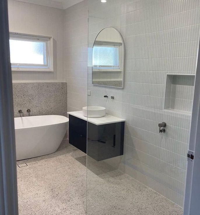 A Bathroom With A Tub, Sink And Mirror — Lake Macquarie Designer Kitchens In Morisset, NSW