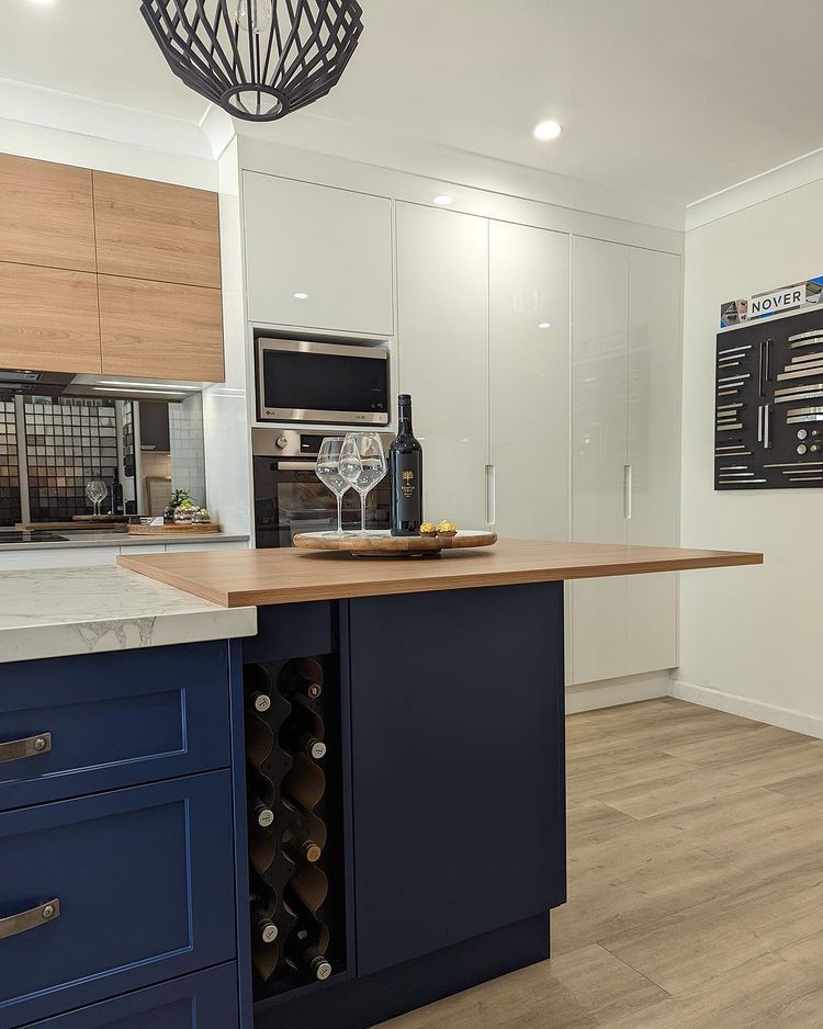 A Kitchen With Blue Cabinets And Marble Counter Tops — Lake Macquarie Designer Kitchens In Wangi Wangi, NSW