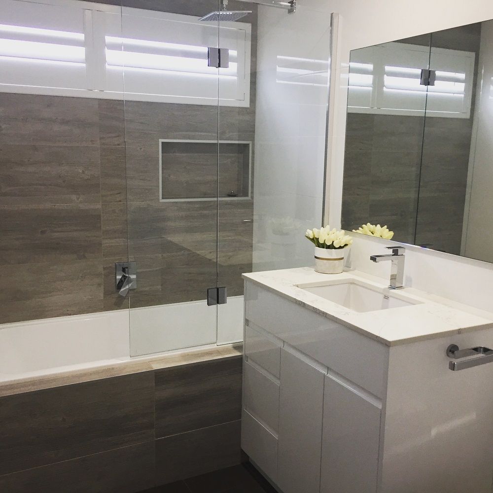 A Bathroom With A Tub, Sink And Mirror — Lake Macquarie Designer Kitchens In Lake Macquarie, NSW