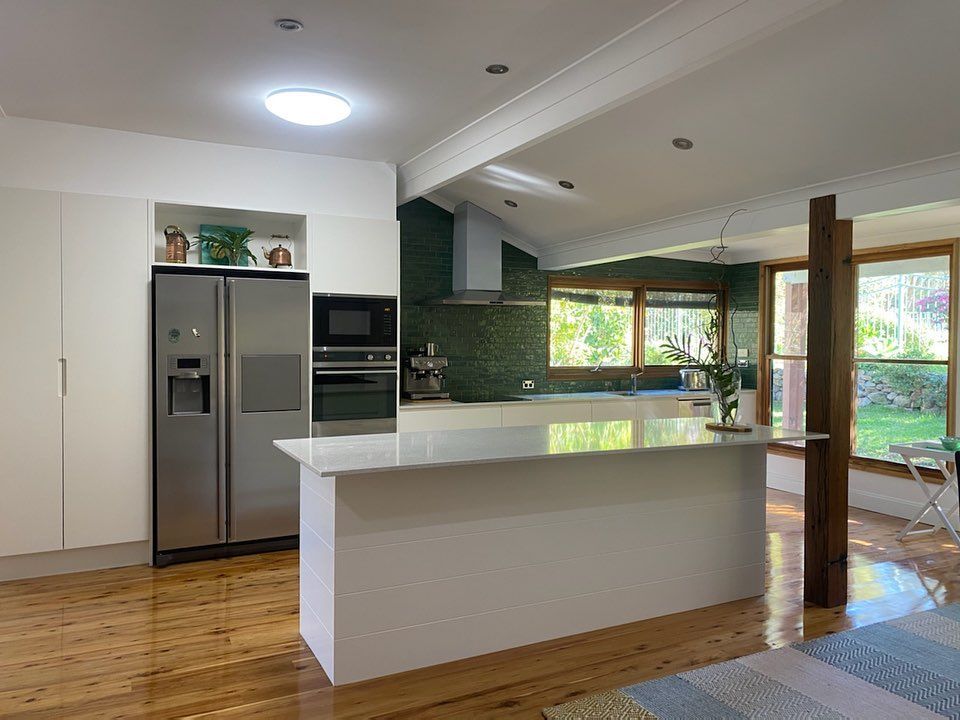 A Kitchen With White Cabinets And White Counter Tops — Lake Macquarie Designer Kitchens In Blacksmiths, NSW