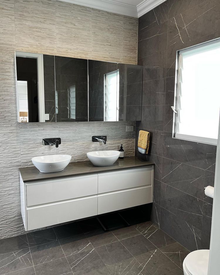 A Bathroom With A Tub, Sink And Mirror — Lake Macquarie Designer Kitchens In Caves Beach, NSW