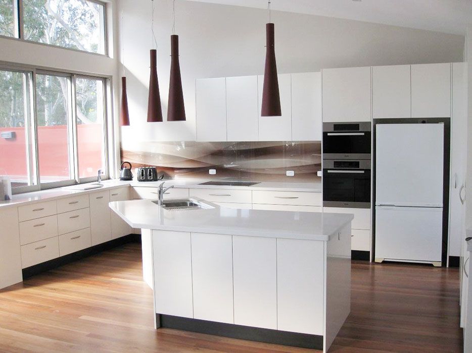 A Kitchen With White Cabinets And White Counter Tops — Lake Macquarie Designer Kitchens In Lake Macquarie, NSW