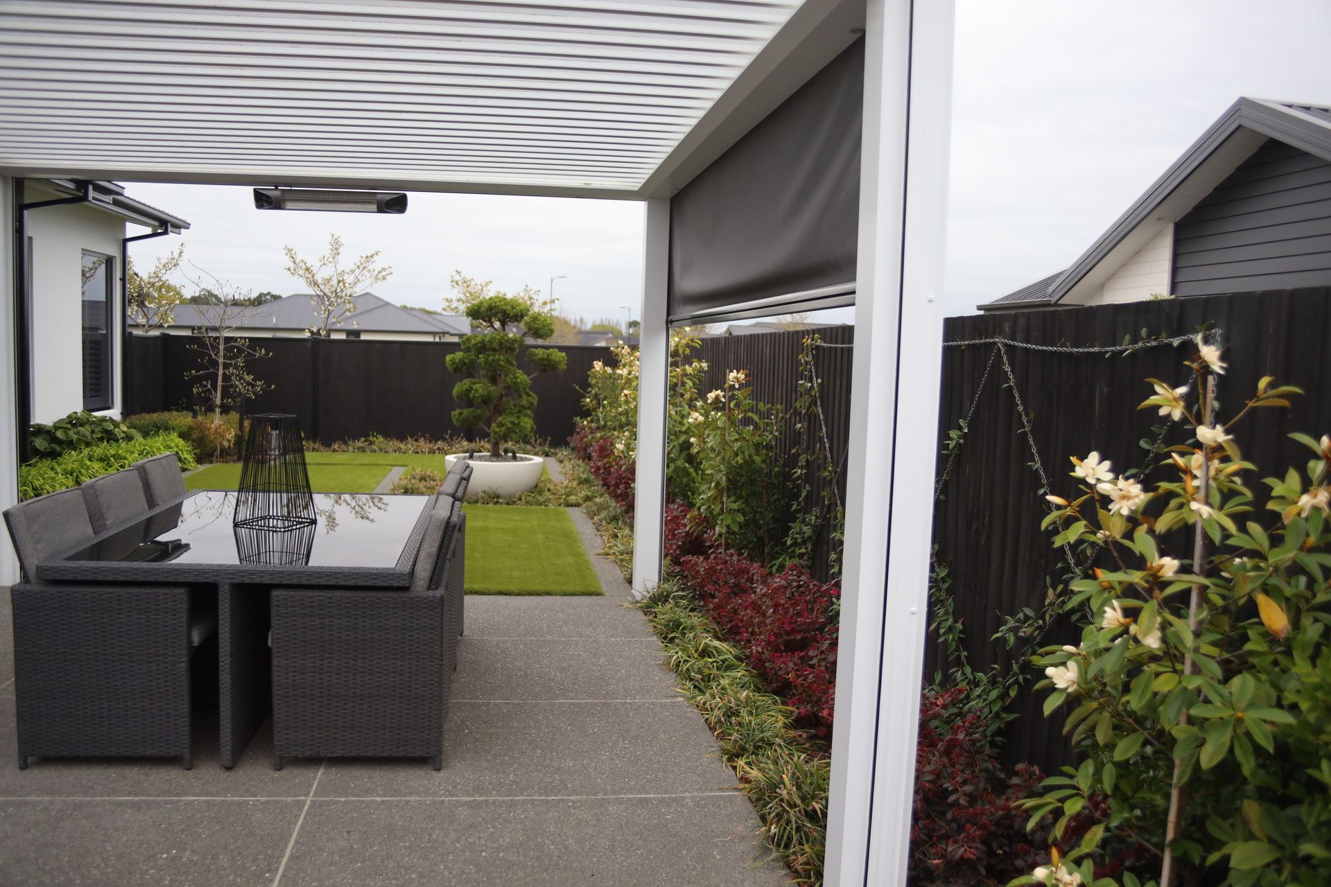 A patio with a table and chairs under a pergola