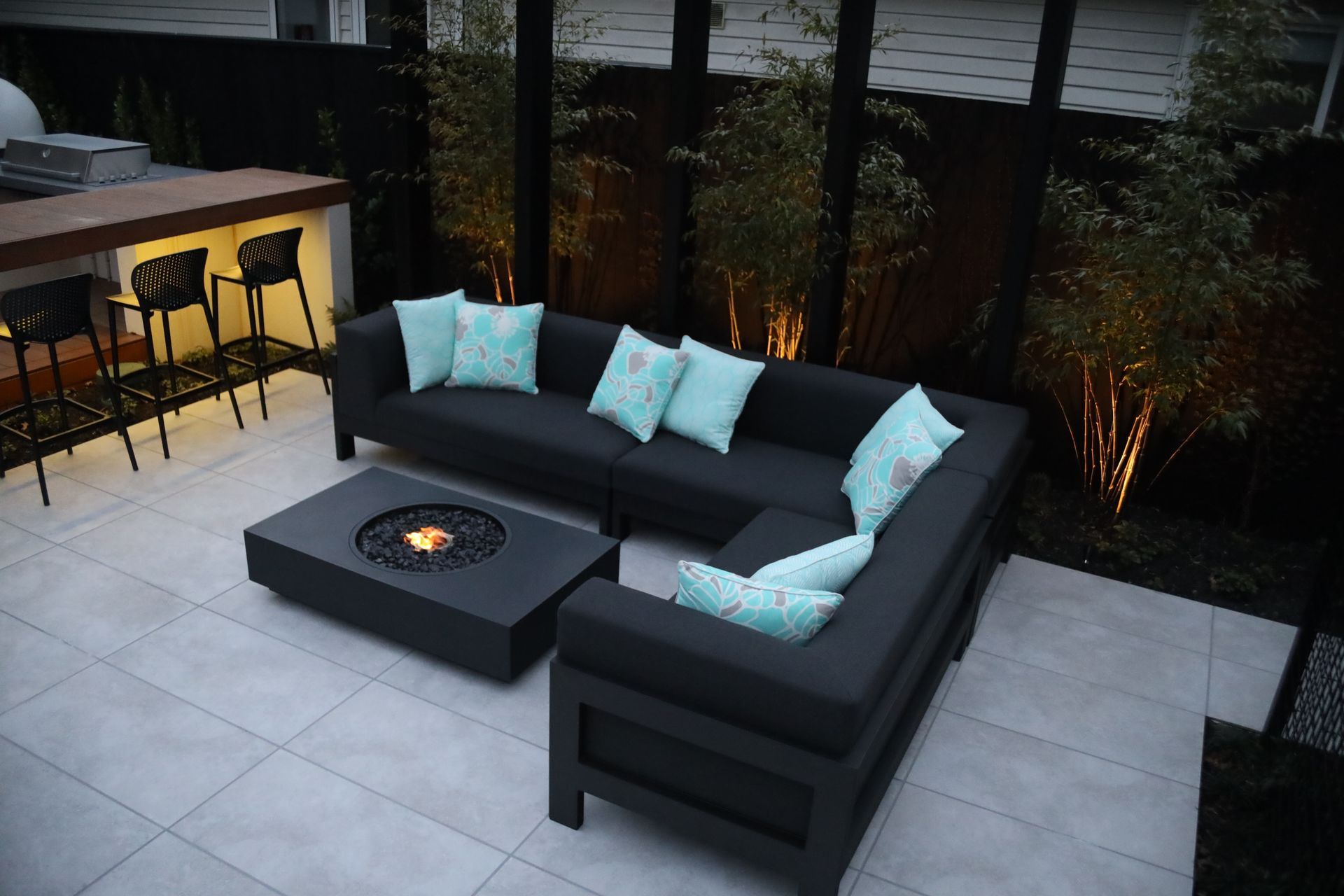 A patio with a couch and a fire pit