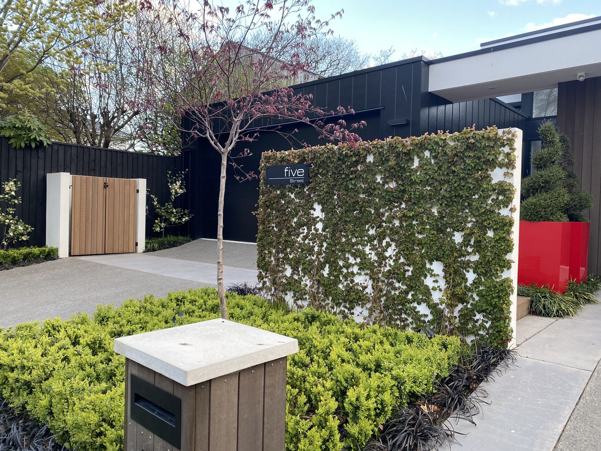 A house with a fence and a mailbox in front of it