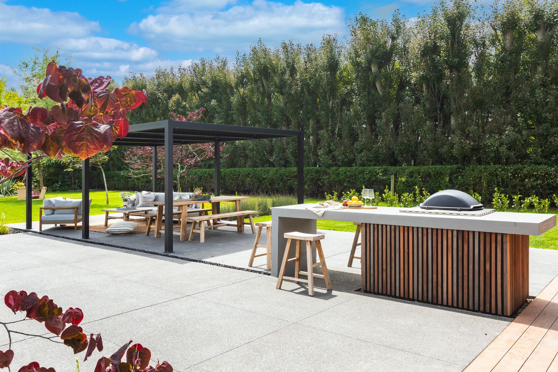 A patio area with a wooden table and stools