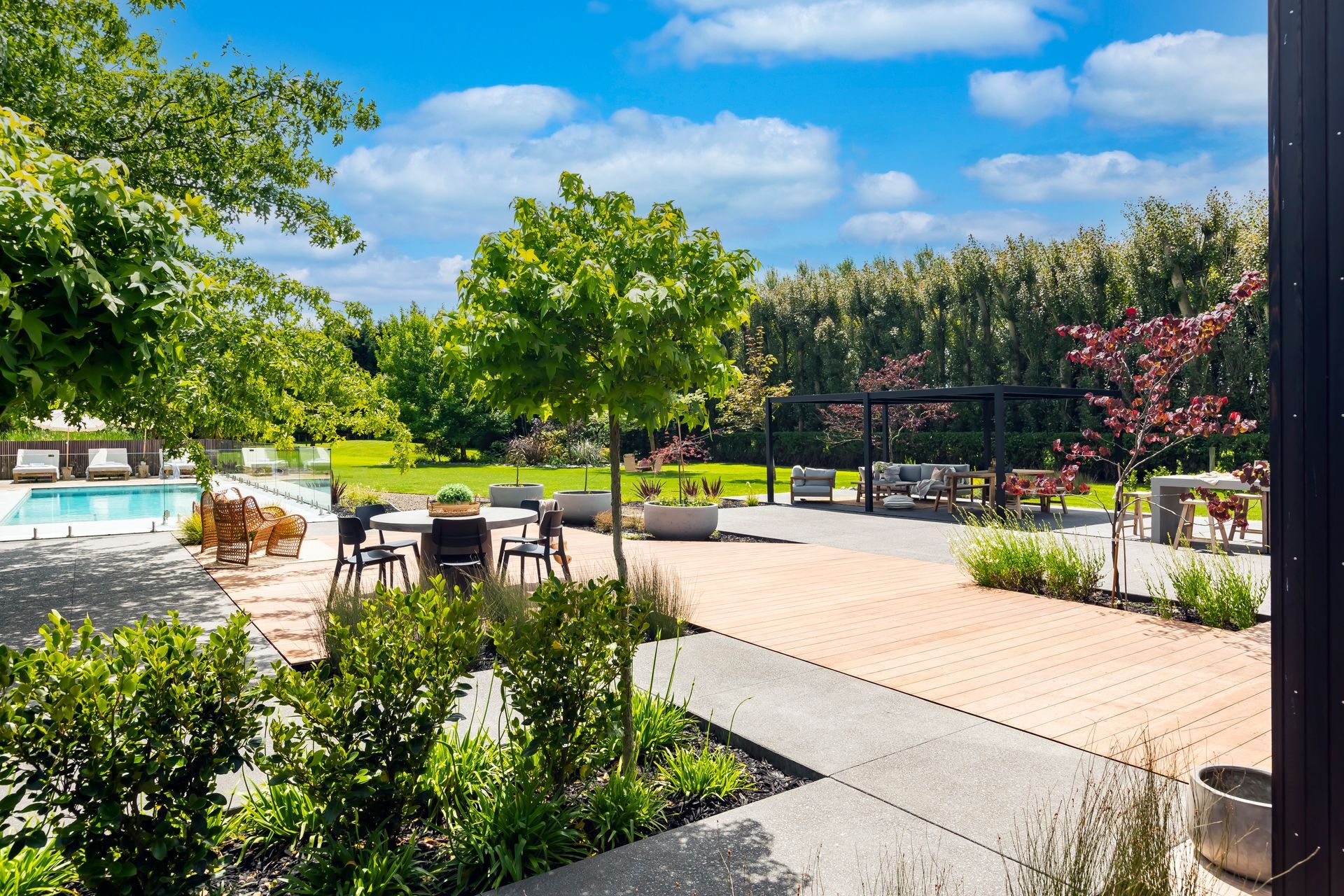 A patio area with a swimming pool and tables and chairs