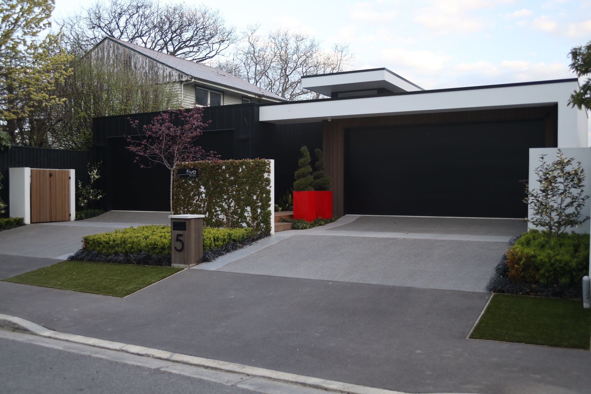 A house with a driveway and a mailbox with the number 5 on it