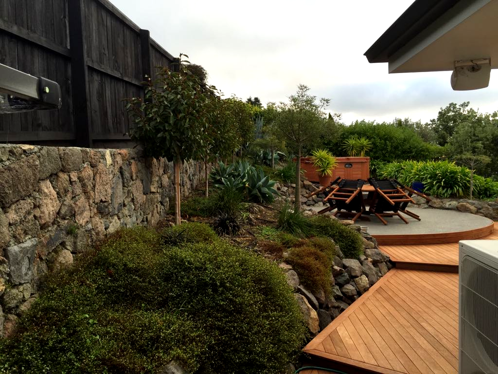A wooden deck with a table and chairs on it
