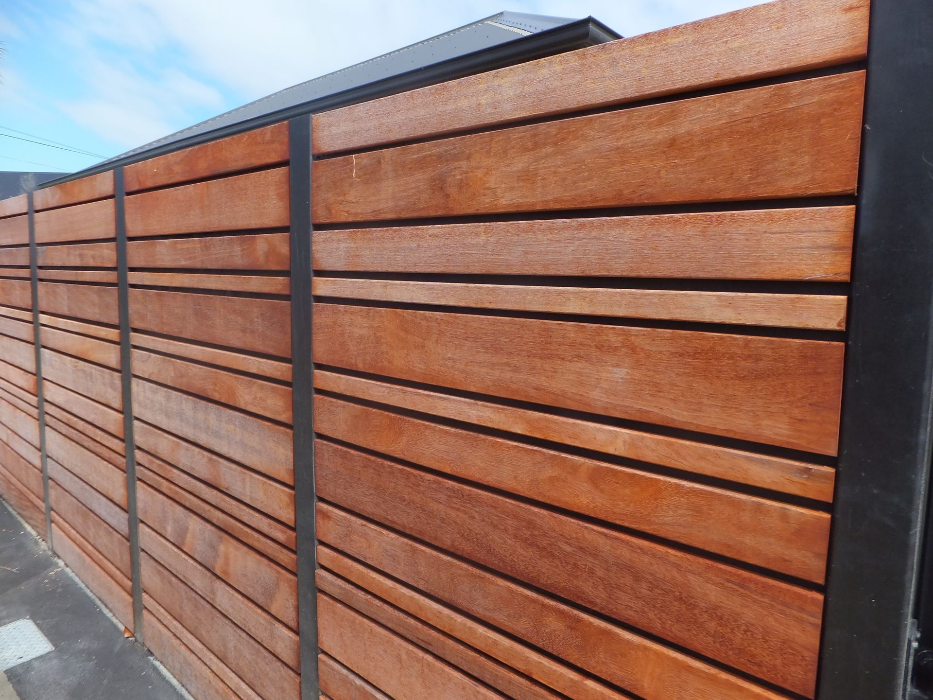 A close up of a wooden fence with a black frame