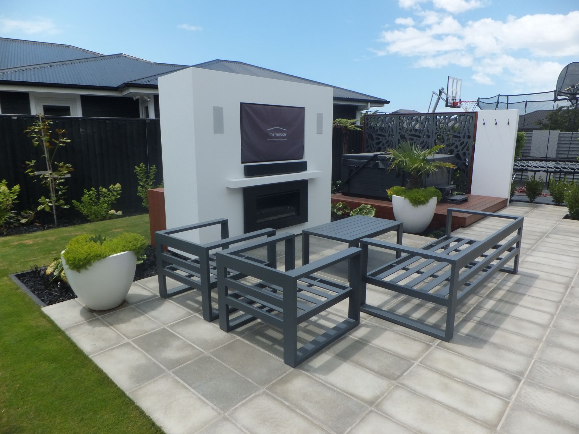 A patio area with a fireplace and chairs