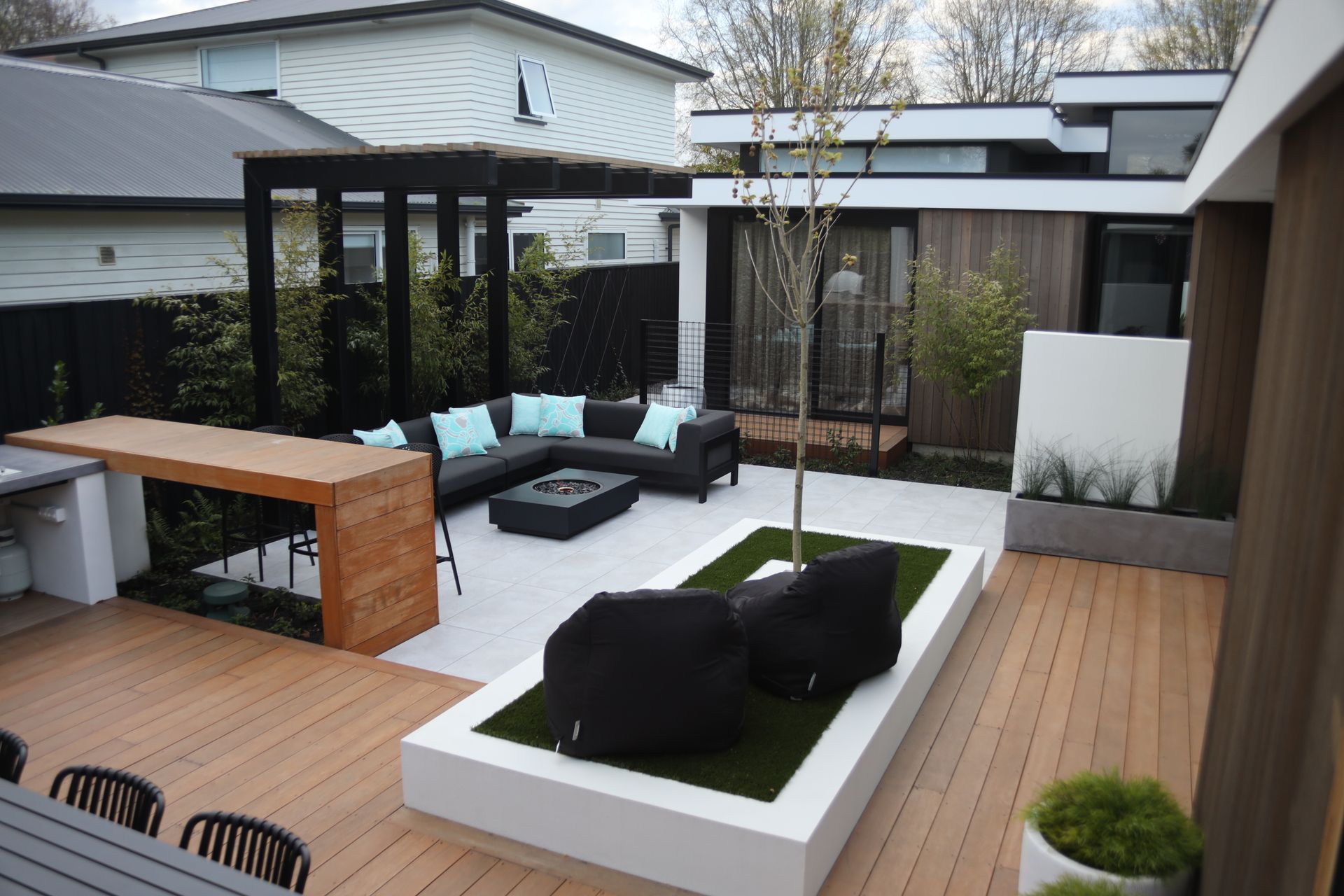 A patio with a couch and chairs in the middle of it