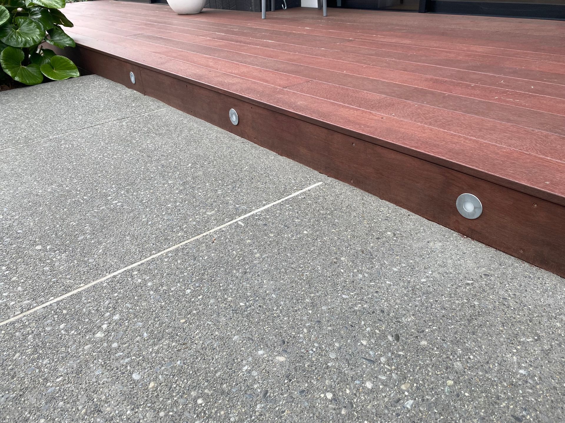 A wooden deck is sitting on top of a concrete floor.