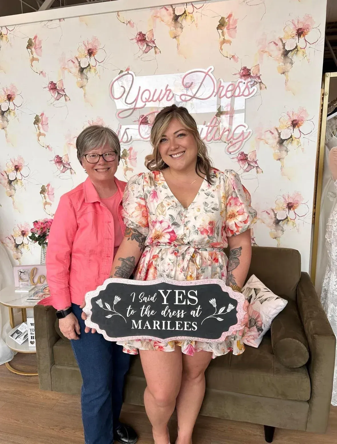 Woman in floral dress holding a 