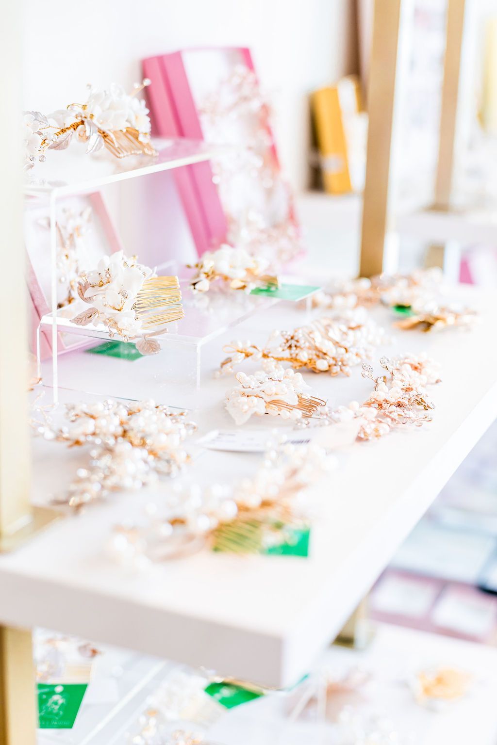 White shelf displaying several floral headpieces with pearls.