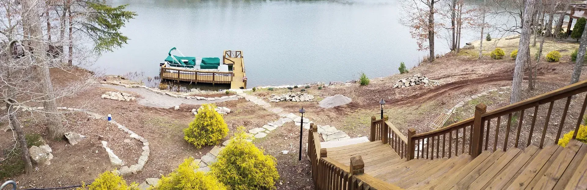 A view of a lake from a deck with stairs leading up to it.