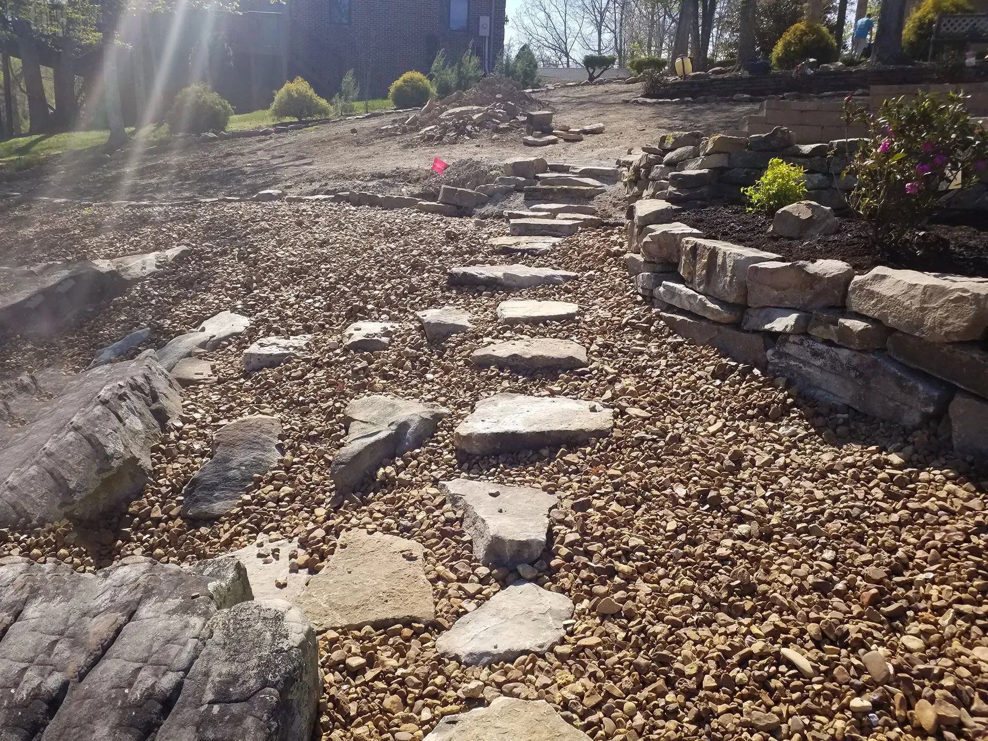 A path made of rocks and mulch in a garden