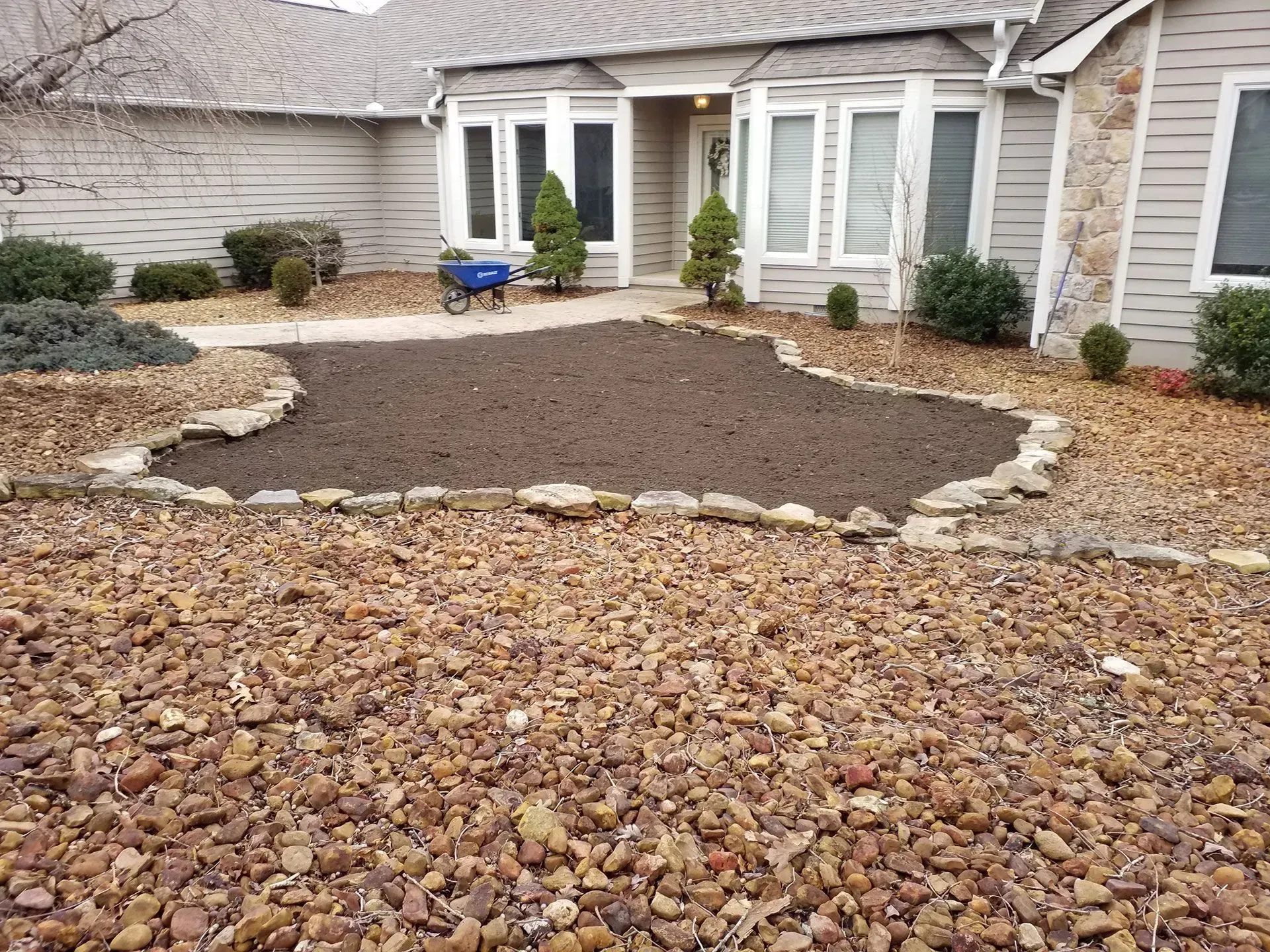 A house with a mulch in front of it.