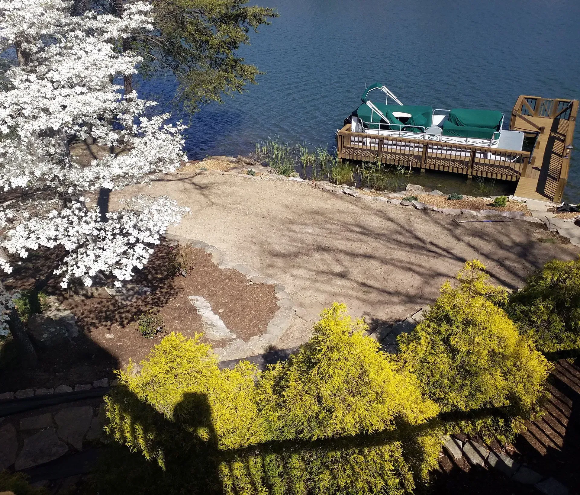 A boat is docked on the shore of a lake
