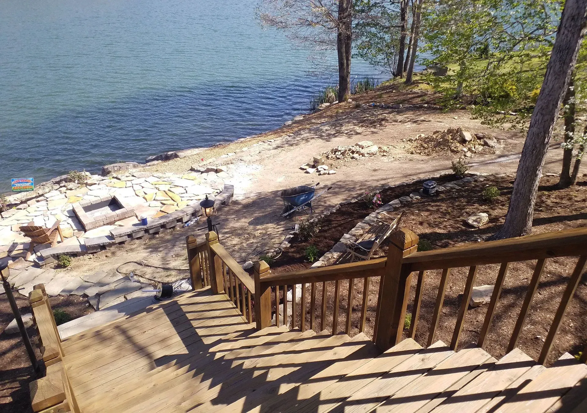 A set of wooden stairs leading to a body of water