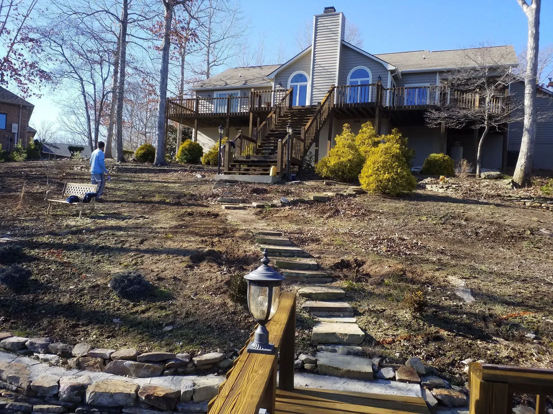 A house with a large deck and stairs leading up to it