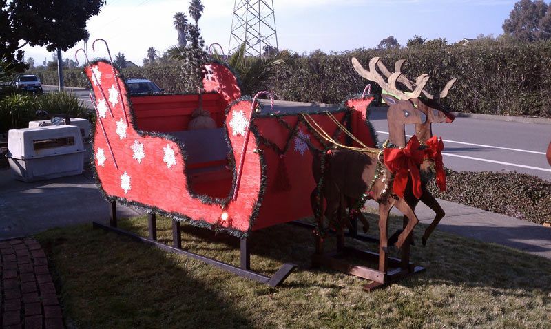 A Red Sleigh with Two Reindeer Pulling it | San Rafael, CA | Earl Farnsworth Express