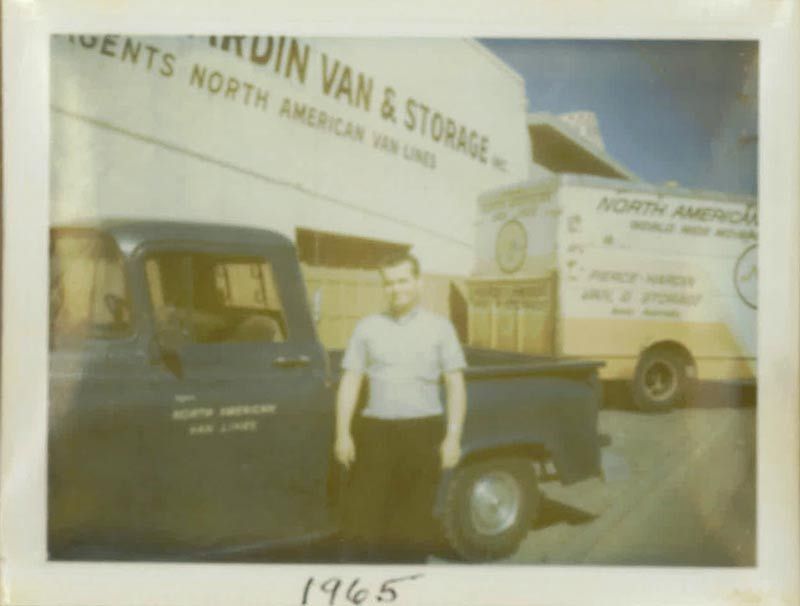 A Man is Standing in front of a Truck that says North American Van & Storage | San Rafael, CA | Earl Farnsworth Express