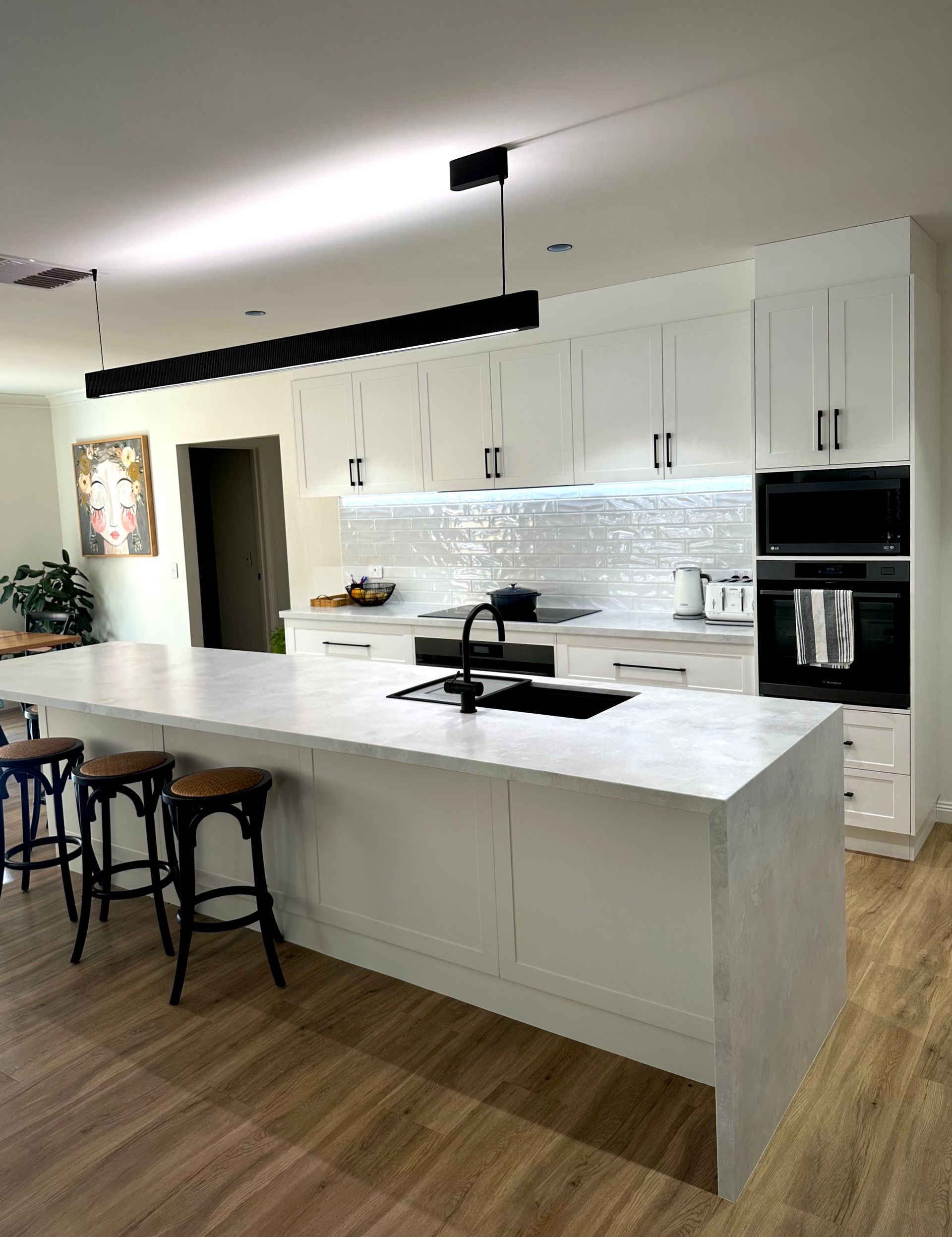 There is a large island in the middle of the kitchen.