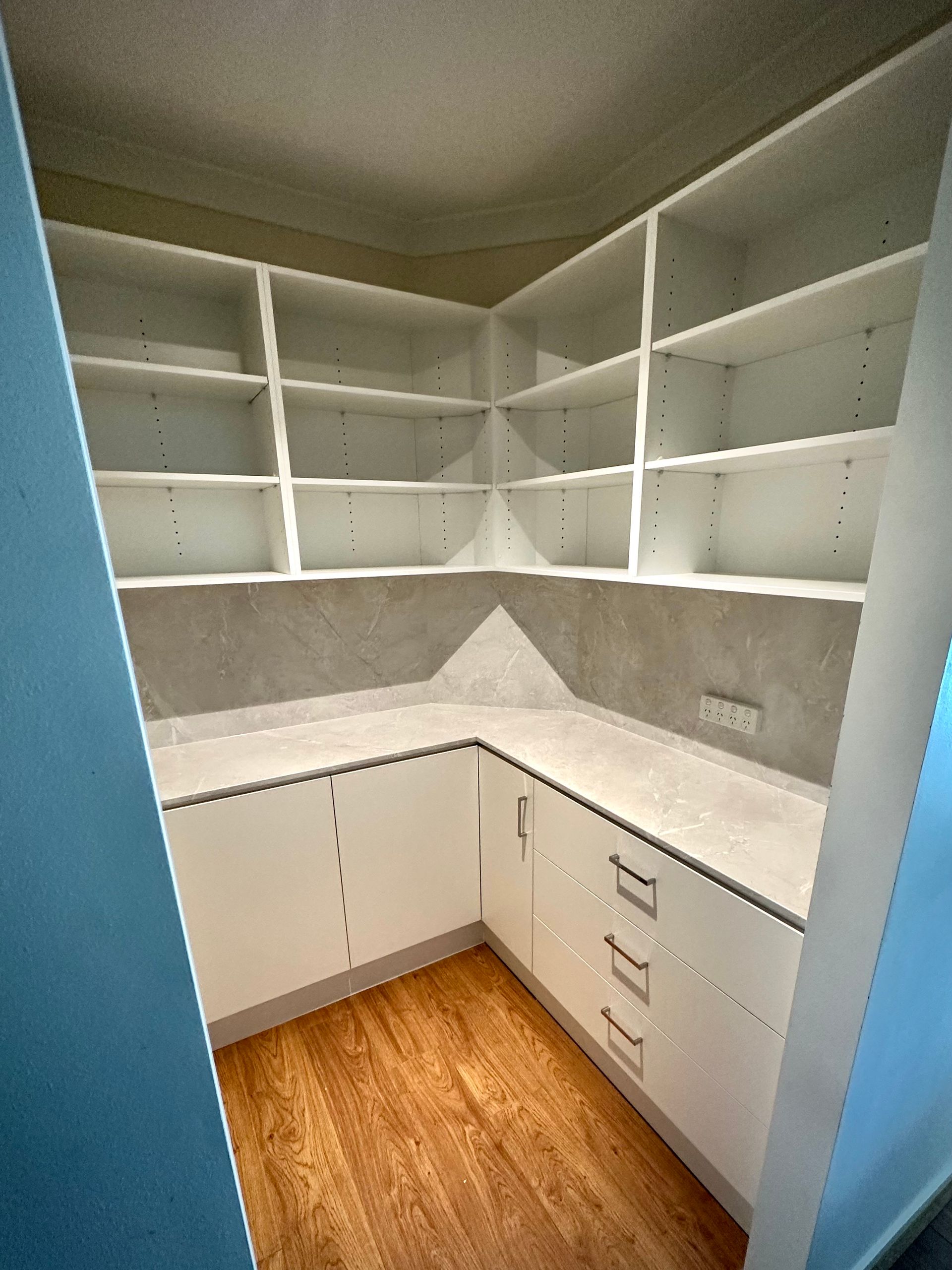 A room with a lot of shelves and drawers in it