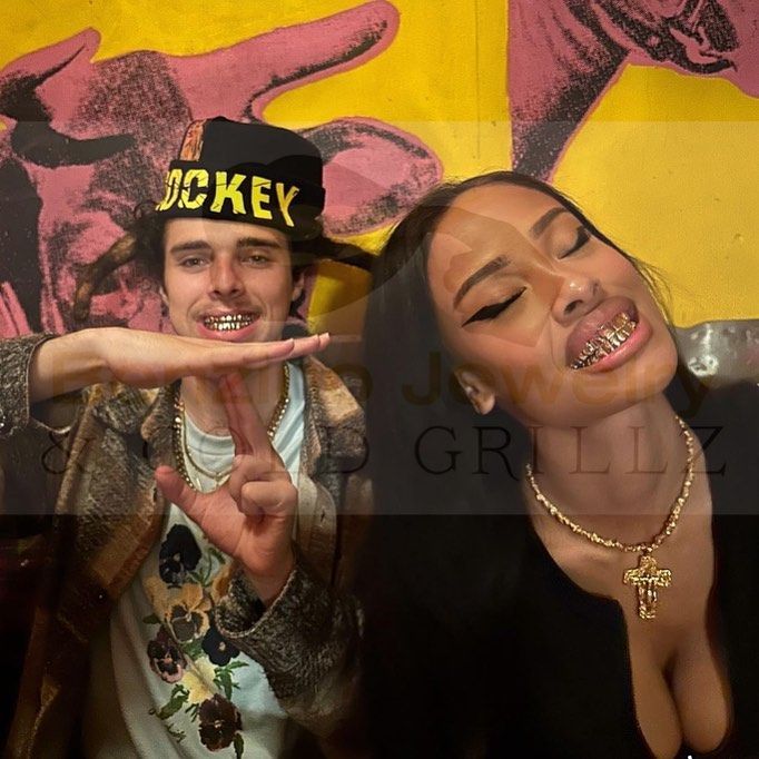 Clients showing off custom gold grillz and silver grillz in South Florida