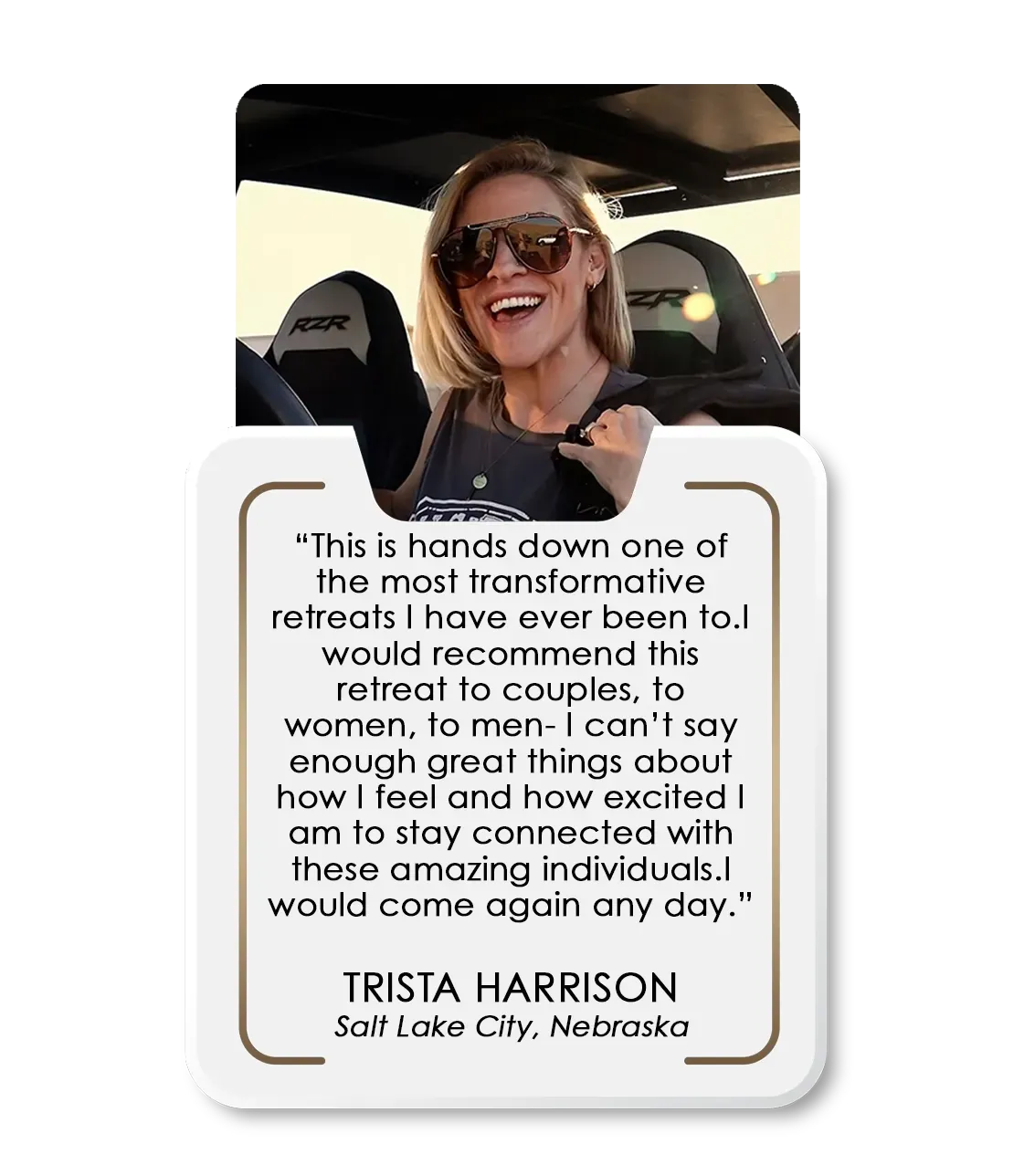 A woman is driving a vehicle with a quote on it.