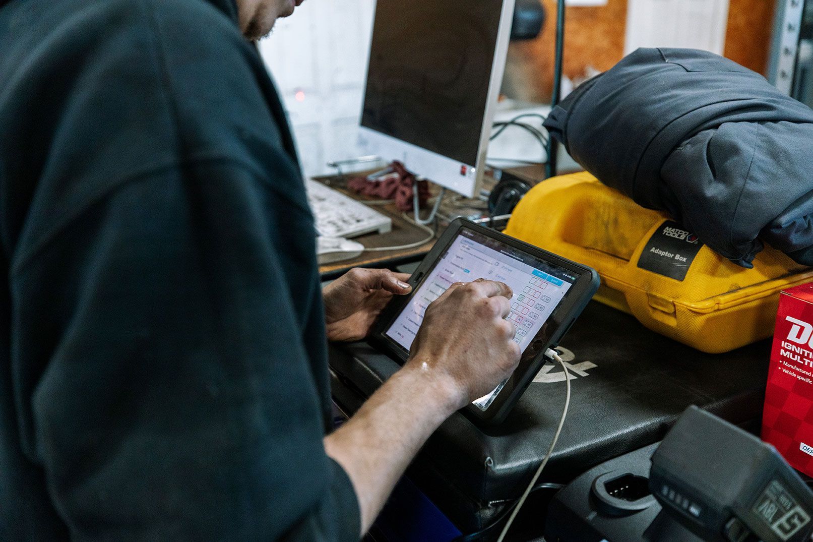 a man is working on the engine of a car