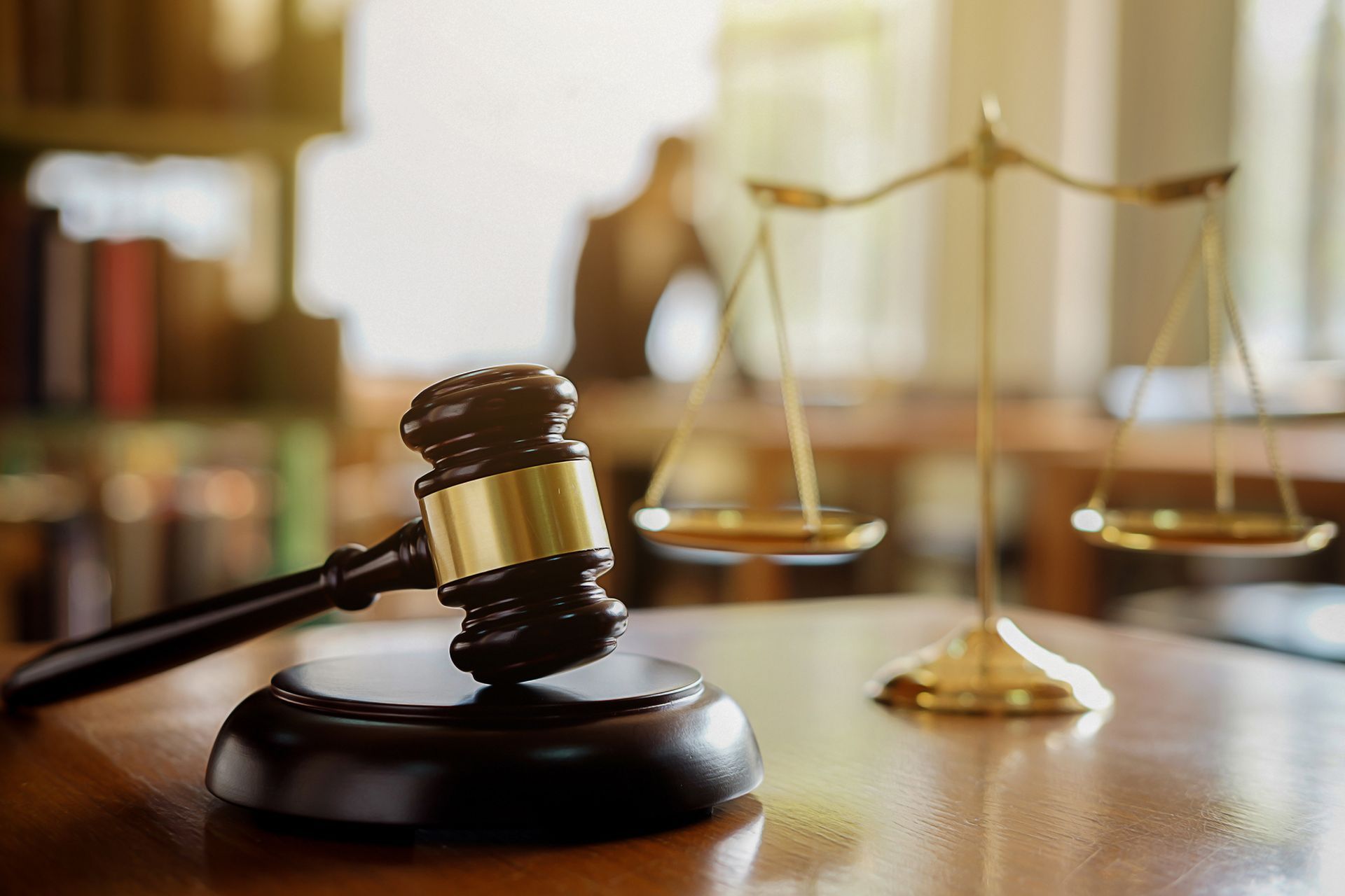Judge’s Gavel and Scales of Justice on Wooden Table