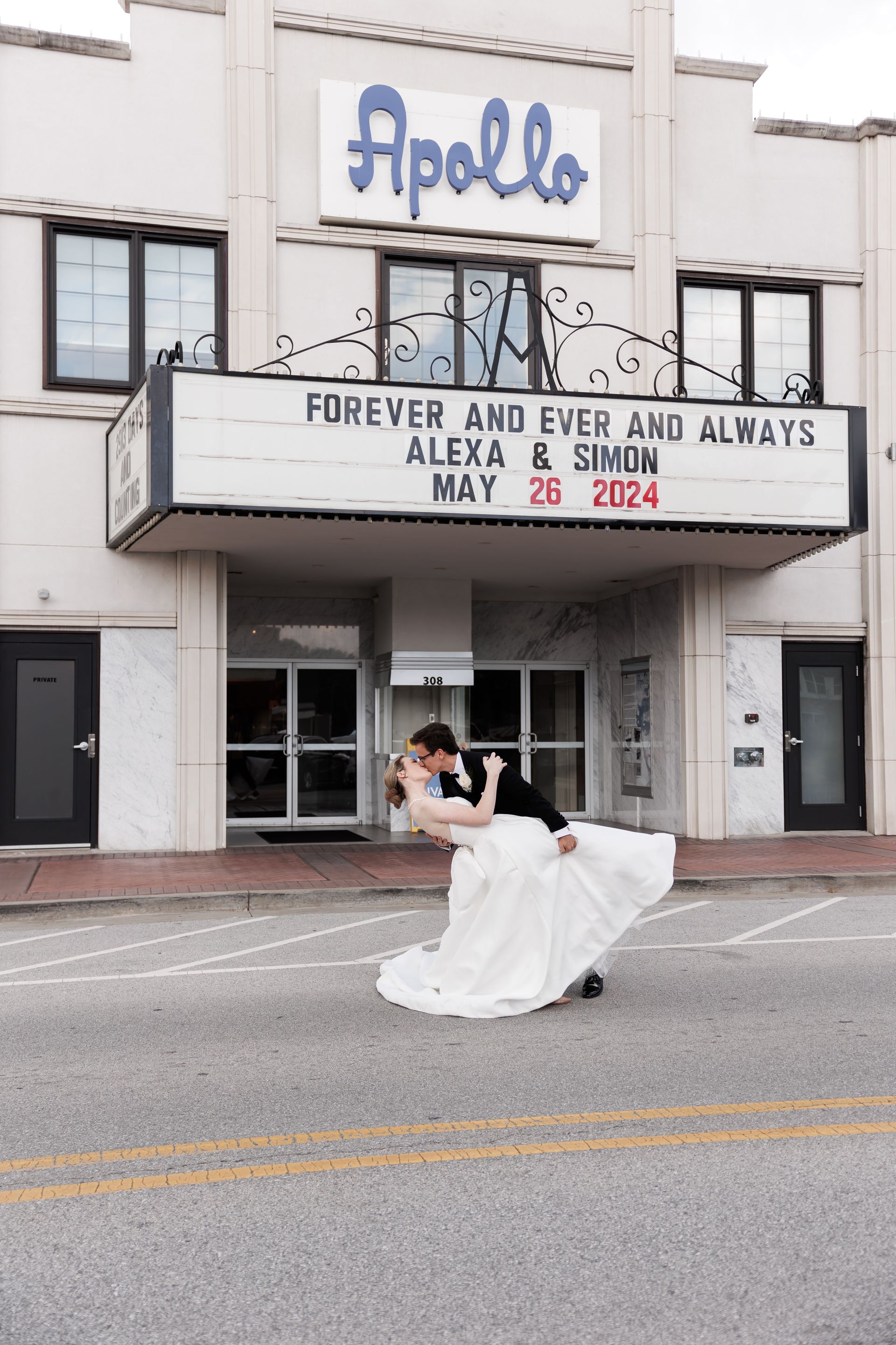 Bride and groom dip in front of the Apollo Theater marquee; 
