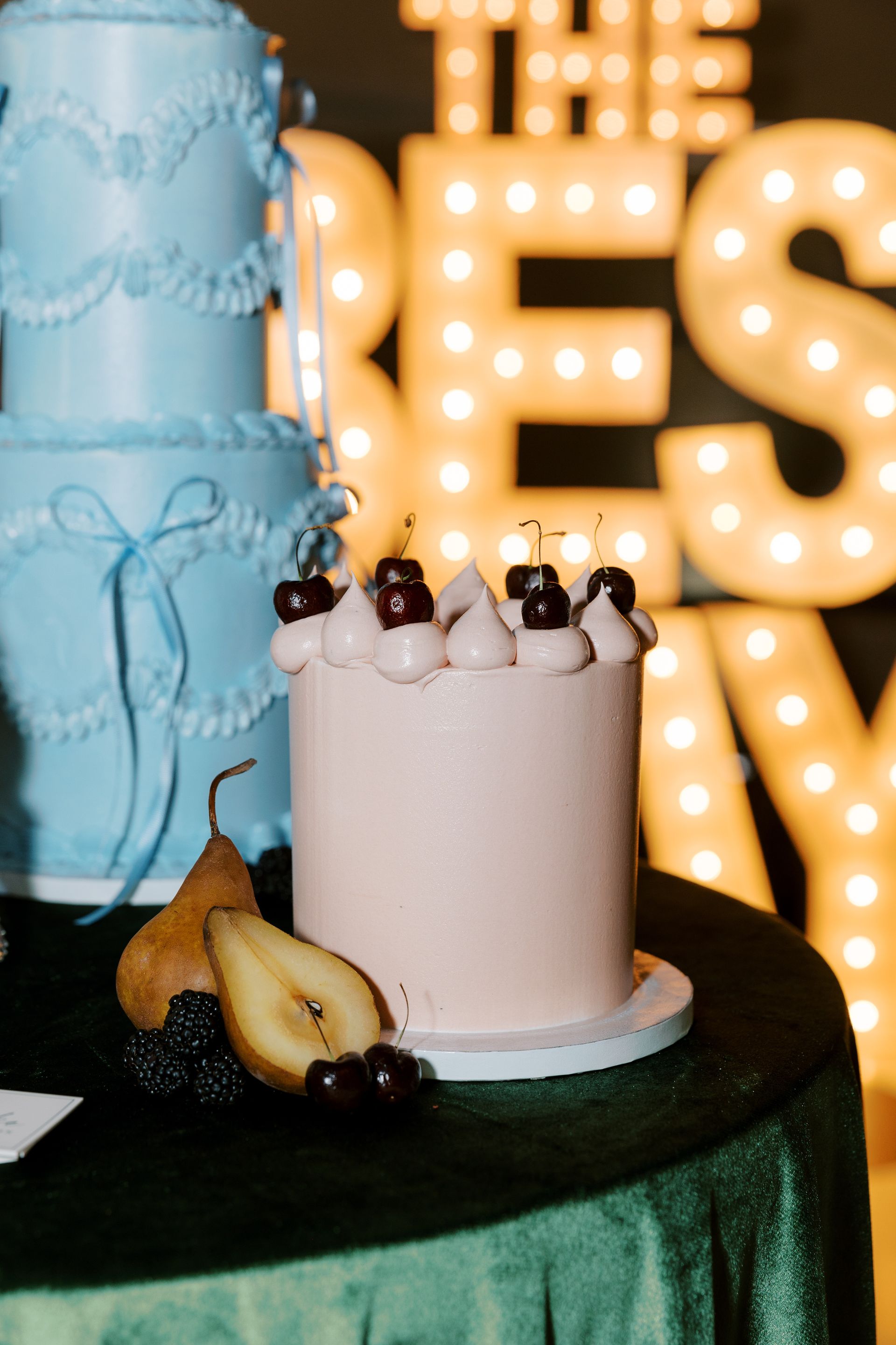 Bartender pouring champagne, smiling. Bar with patrons, flowers, and champagne bottles.